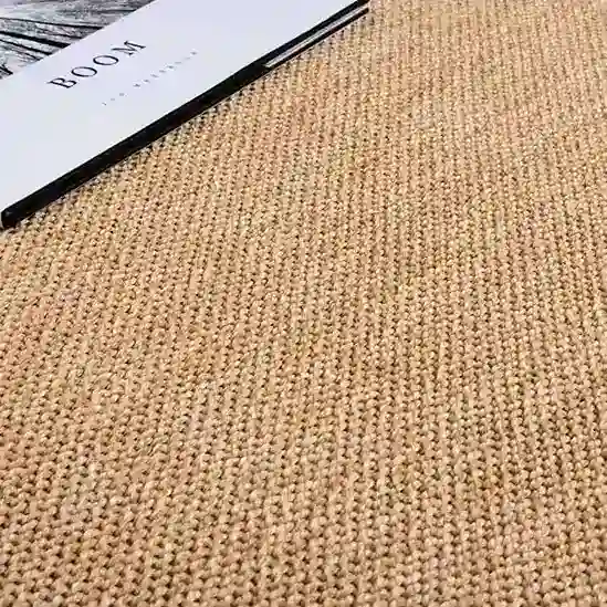 Soft beige woven rug, ideal for living rooms and bedrooms. Durable and stylish carpet for home decor.